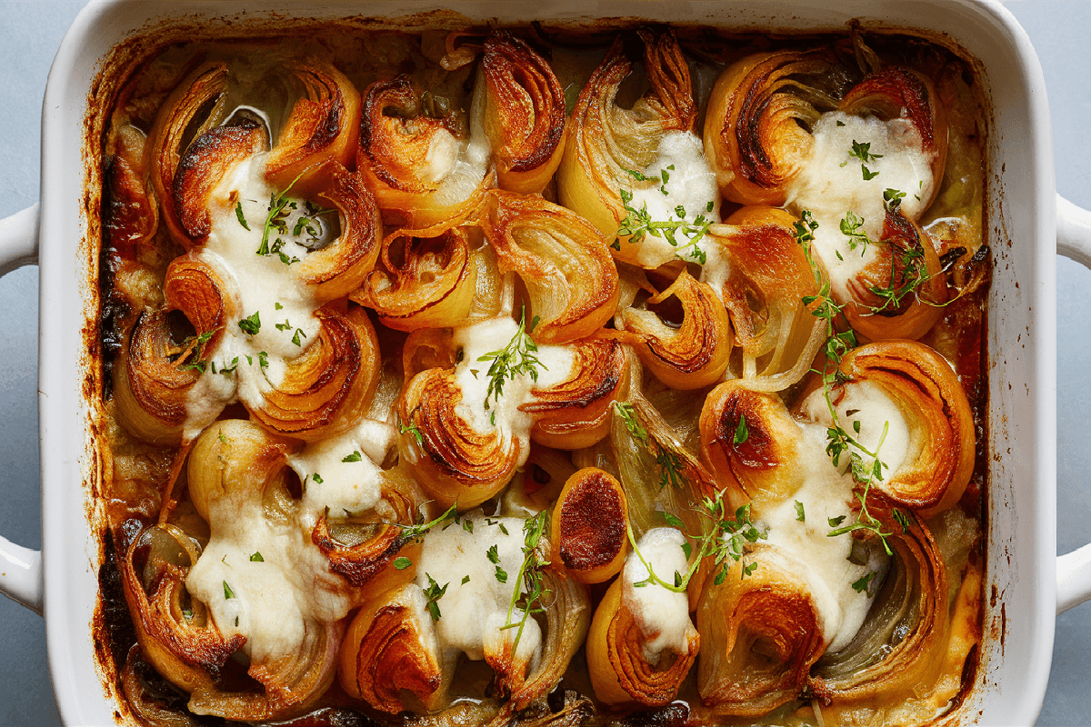 A baking dish of golden, cheesy Tennessee Onions fresh out of the oven